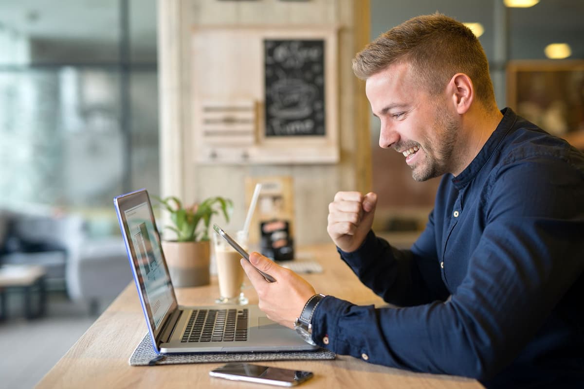 Happy professional working on laptop
